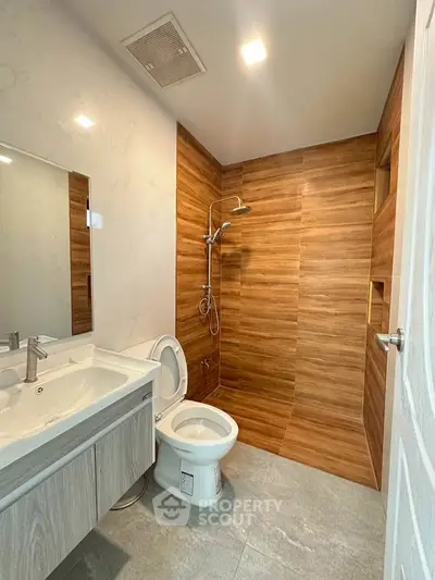 Modern bathroom with wooden tile shower and sleek vanity