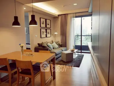 Modern living room with cozy seating and dining area, featuring a large window with city view.