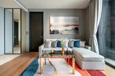 Modern living room with stylish decor, large window, and comfortable seating area.