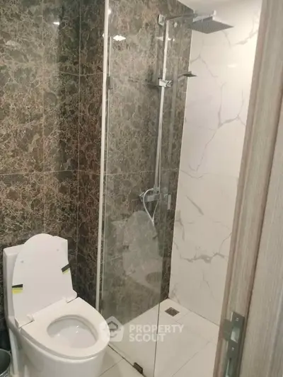 Modern bathroom with glass shower and marble tiles