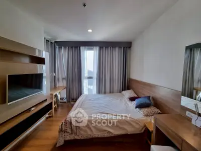 Spacious bedroom with modern furnishings and natural light