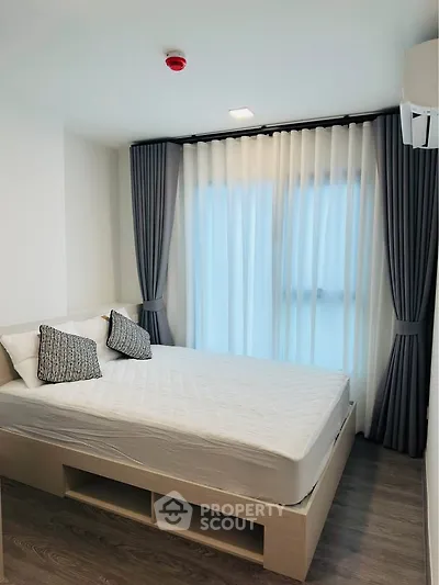 Modern bedroom with stylish curtains and cozy bed in a bright apartment.
