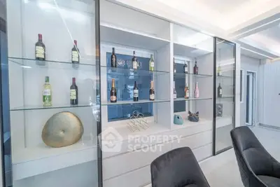 Modern living room with stylish glass shelving and wine display