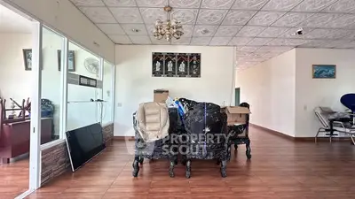 Spacious interior with elegant furniture and decorative ceiling tiles, ideal for stylish living.
