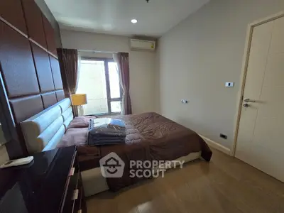 Modern bedroom with stylish decor and natural light in a contemporary apartment.