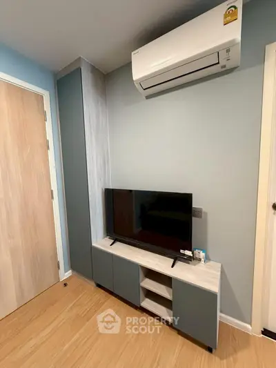 Modern living room with sleek TV unit and air conditioning