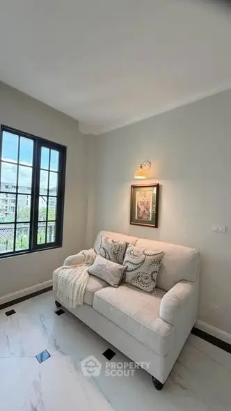 Cozy living room with elegant sofa and large window view