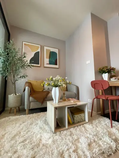 Cozy living room with modern decor and plush rug, perfect for relaxation.