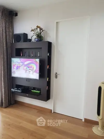 Modern living room with sleek TV unit and wooden flooring