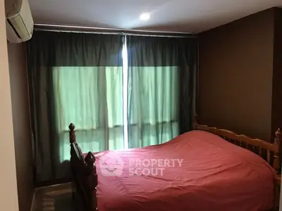 Cozy bedroom with wooden bed and air conditioning, ideal for restful nights.