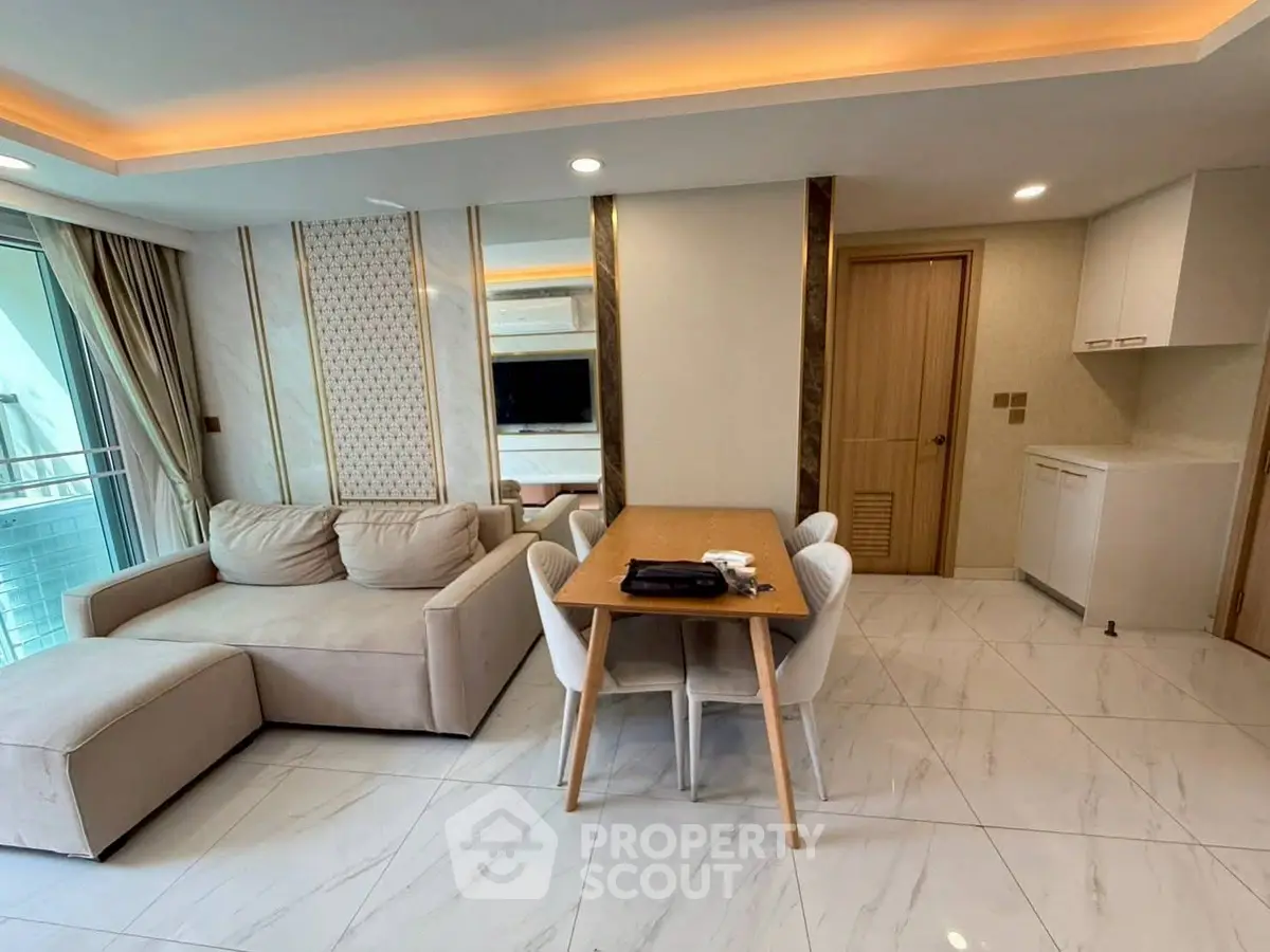 Modern living room with elegant decor and dining area, featuring a cozy sofa and stylish furniture.