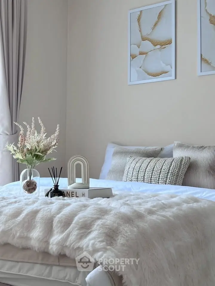 Cozy bedroom with plush bedding and elegant decor, perfect for relaxation.