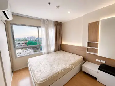 Modern bedroom with large window and city view, featuring a comfortable bed and stylish decor.