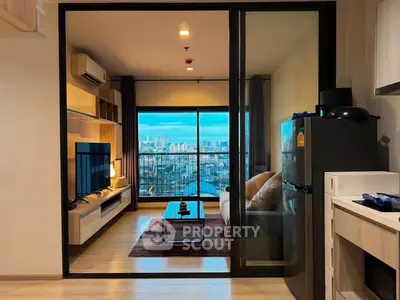 Modern living room with city view, featuring sleek furniture and large glass doors opening to a balcony.