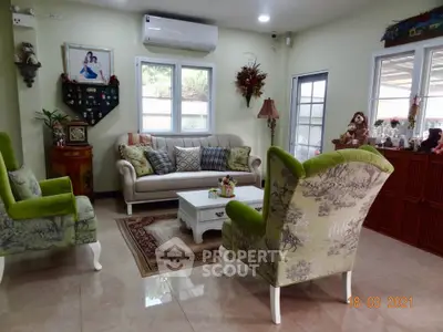 Charming living room with elegant furniture and natural light, perfect for cozy gatherings.