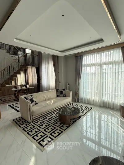 Luxurious modern living room with elegant staircase and large windows