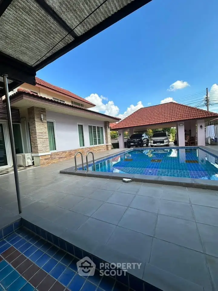 Stunning villa with private pool and spacious patio under clear blue skies.