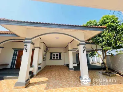 Charming single-story home with tiled patio and archways, perfect for family living.