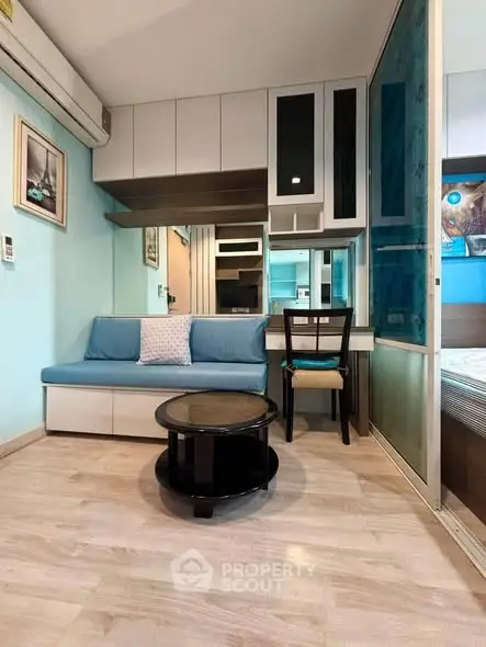 Charming compact living room with modern decor and cozy seating in a stylish apartment.