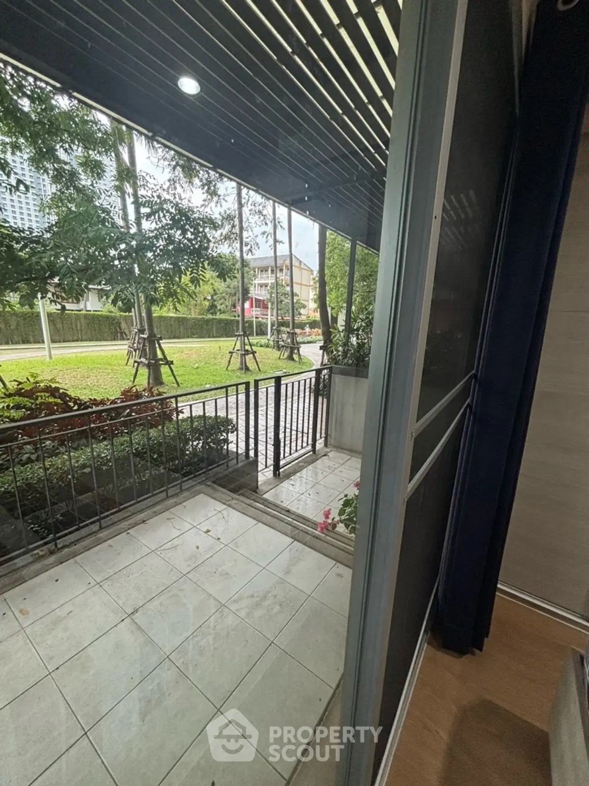 Charming garden view from a modern apartment balcony, perfect for relaxation and enjoying nature.