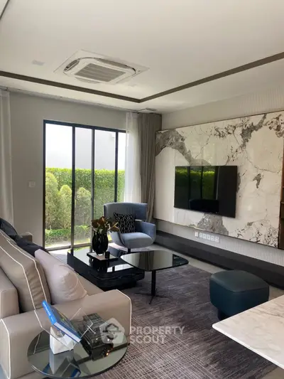 Luxurious modern living room with elegant decor and large windows
