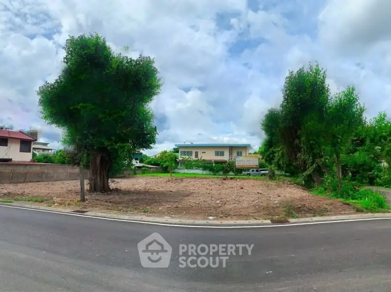 Vacant land plot with lush trees, perfect for building your dream home.