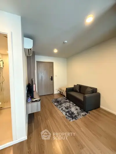 Modern living room with sleek design and cozy sofa in a stylish apartment.