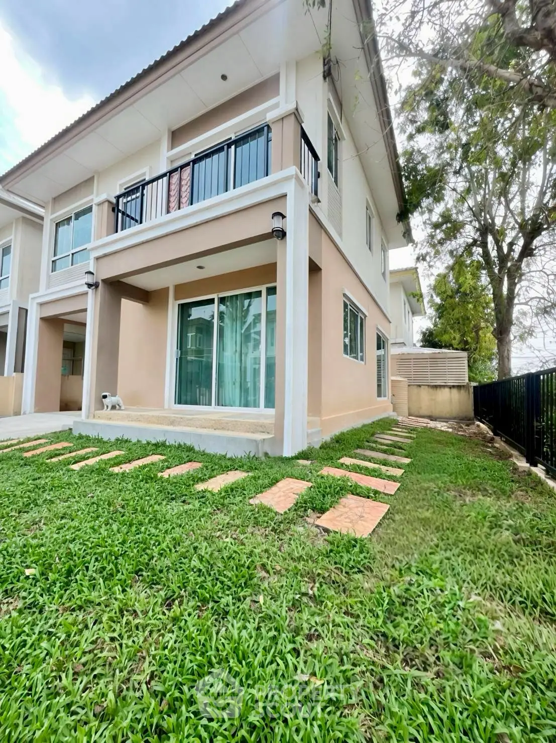 Charming two-story home with lush green lawn and modern exterior design.