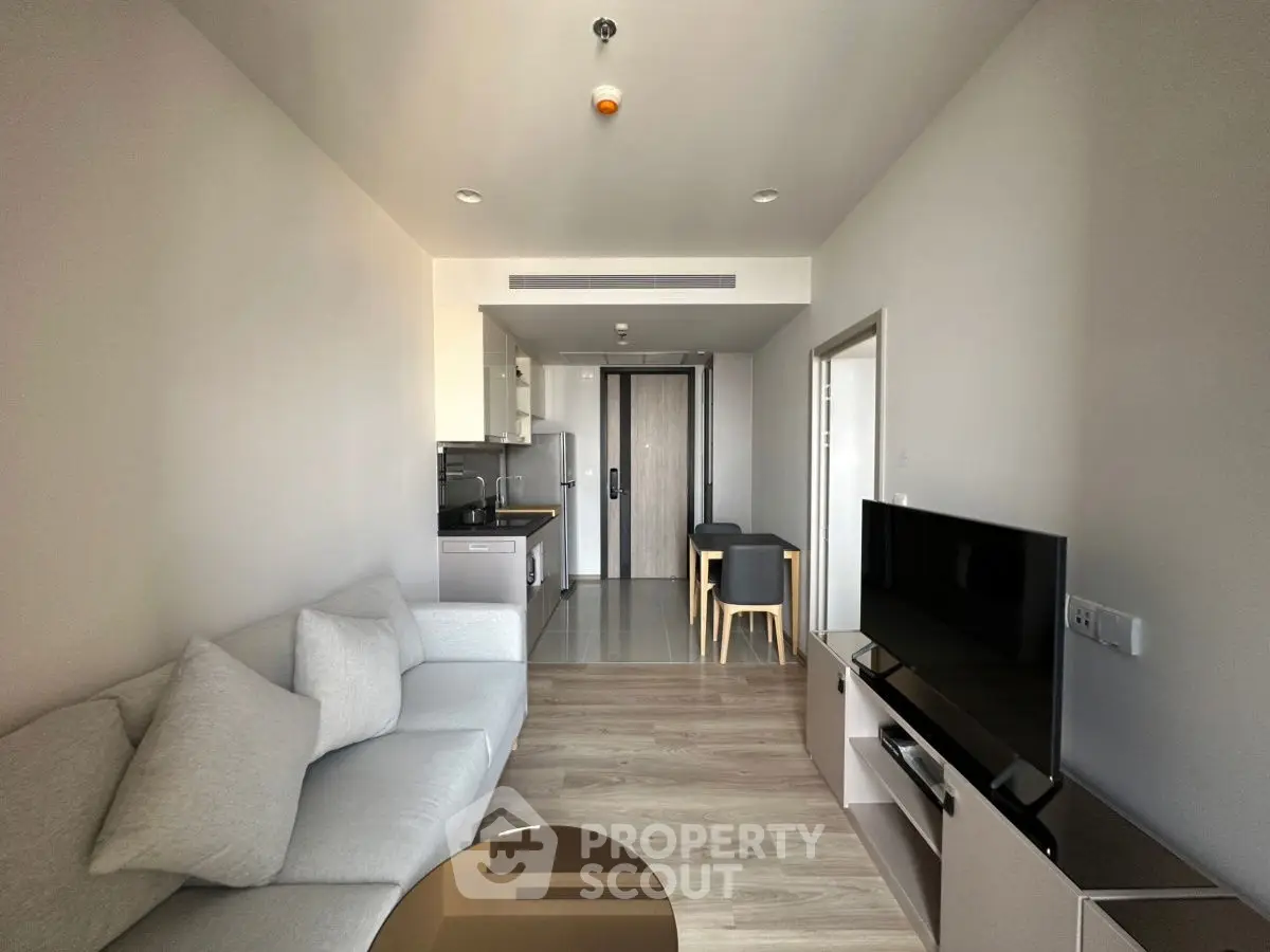 Modern living room with sleek furniture and open kitchen layout