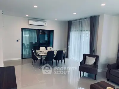 Spacious modern living room with dining area and large windows