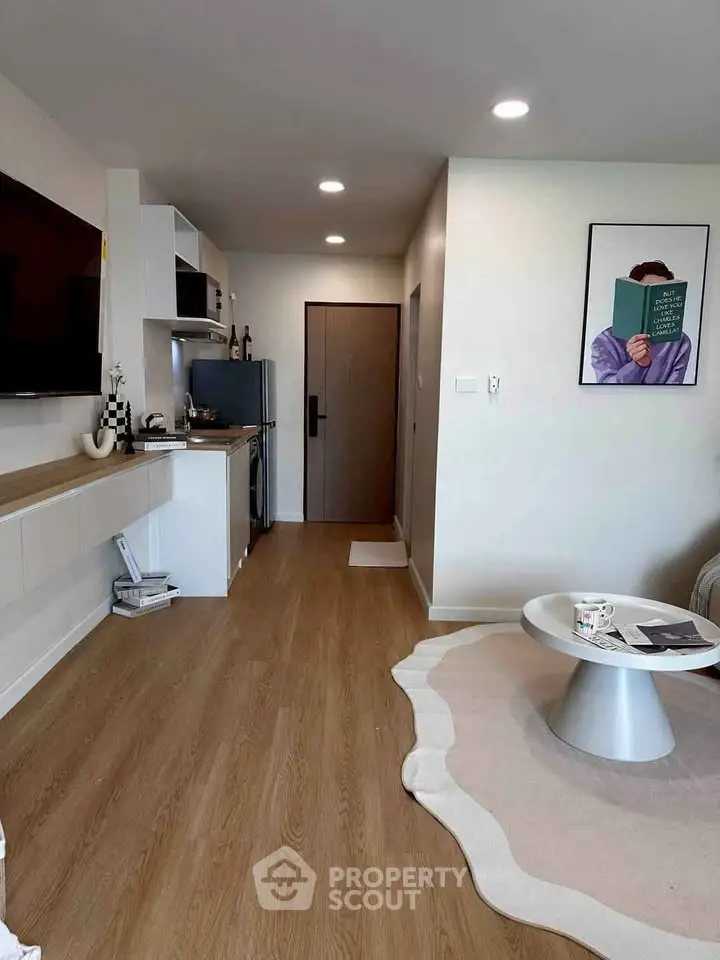 Modern living room with stylish decor and open layout, featuring hardwood floors and contemporary furniture.