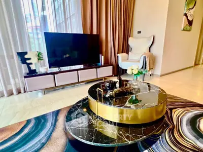 Luxurious living room with modern decor, featuring a stylish marble coffee table and elegant furnishings.