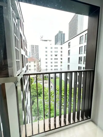 Modern urban balcony with cityscape view, perfect for relaxation.