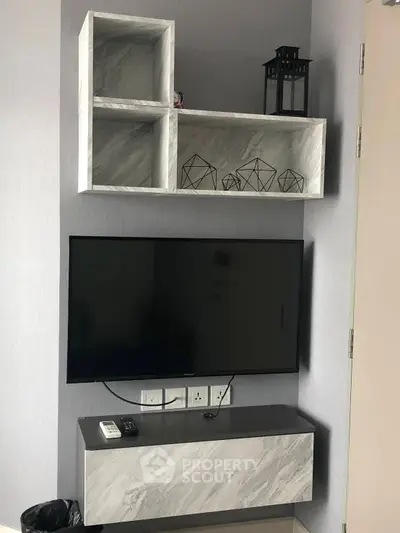 Modern living room with sleek TV setup and stylish shelving