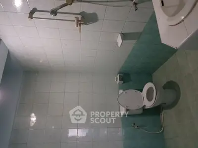 Spacious bathroom with tiled walls and modern fixtures