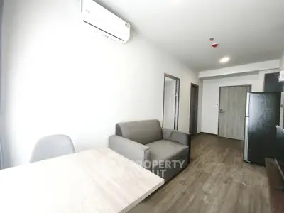 Modern apartment interior with cozy living area and sleek kitchen design.