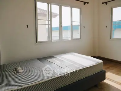Bright bedroom with large windows and minimalist decor, perfect for natural light lovers.