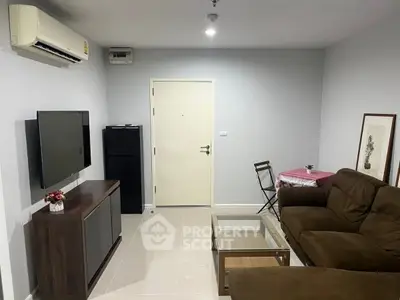 Cozy living room with modern furniture and air conditioning, perfect for relaxation.
