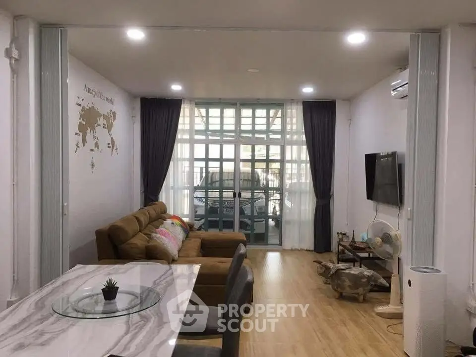 Modern living room with stylish decor and large windows for natural light.