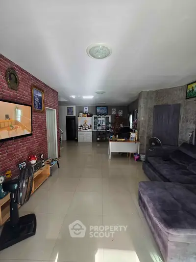 Spacious living room with modern decor and large sectional sofa, perfect for family gatherings.