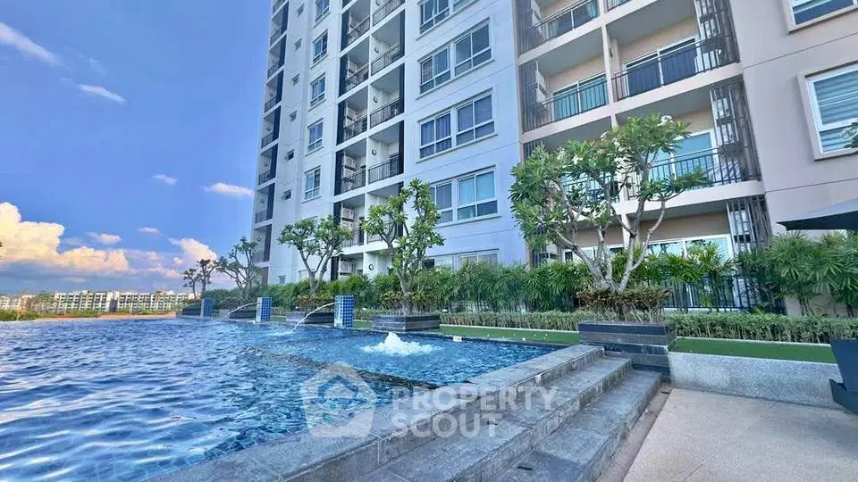 Luxurious apartment building with stunning pool and lush greenery