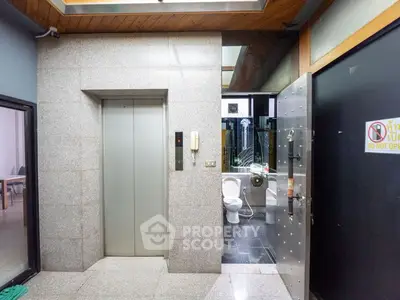 Modern building interior with elevator and unique bathroom design
