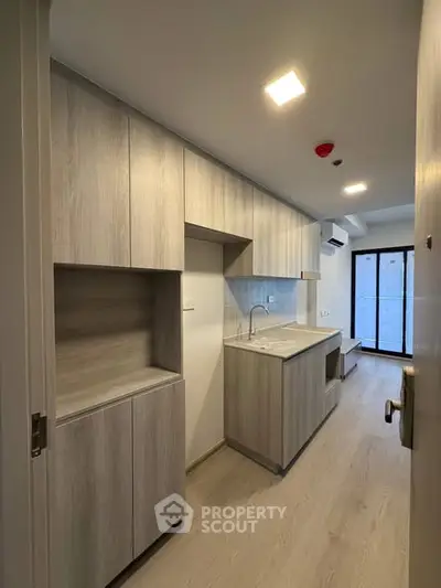 Modern kitchen with sleek cabinetry and minimalist design in a contemporary apartment.