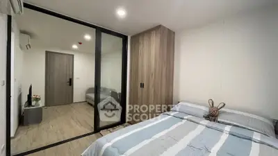 Modern bedroom with wooden wardrobe and glass partition in stylish apartment