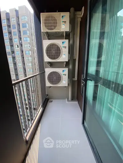Modern balcony with air conditioning units and city view in high-rise building