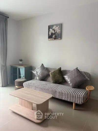 Modern living room with stylish sofa and elegant decor, perfect for relaxation and entertaining guests.