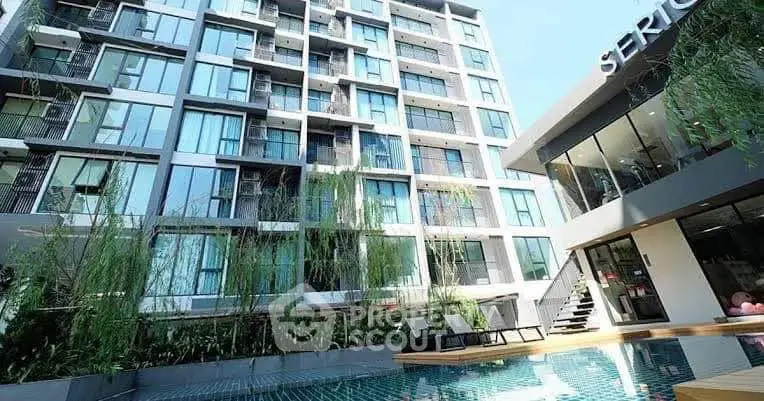 Modern apartment building with pool and lush greenery, perfect for urban living.