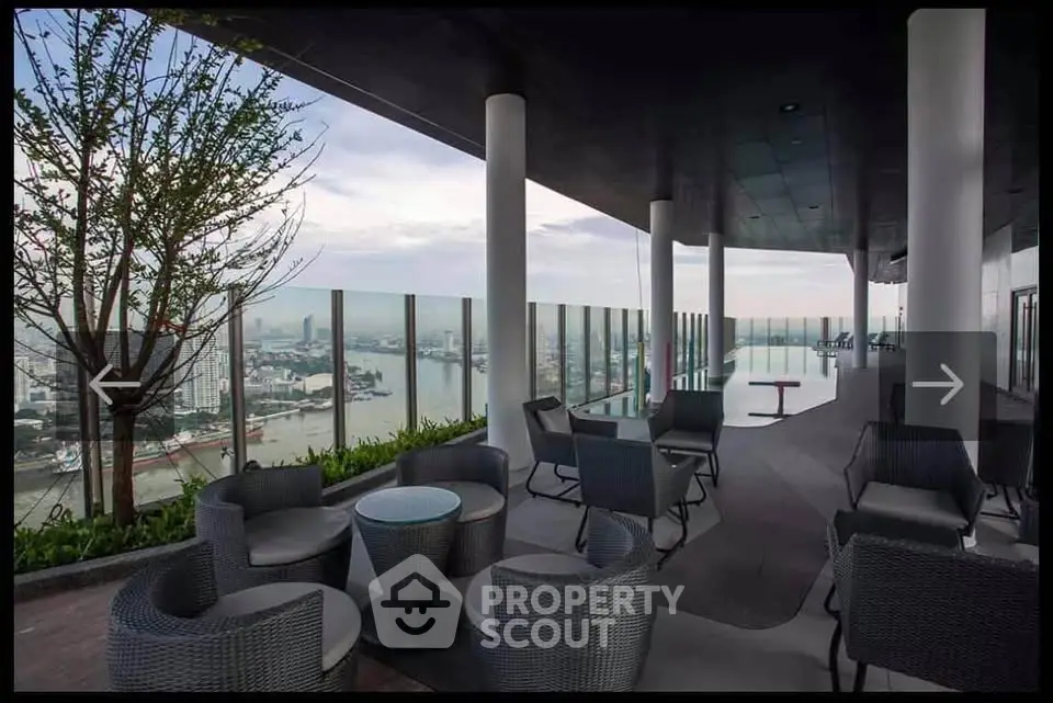 Stunning rooftop terrace with panoramic city and river views, modern seating, and sleek design.