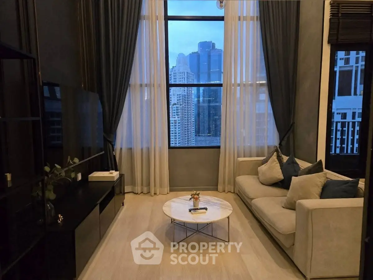 Luxurious living room with stunning city view, elegant decor, and floor-to-ceiling windows.