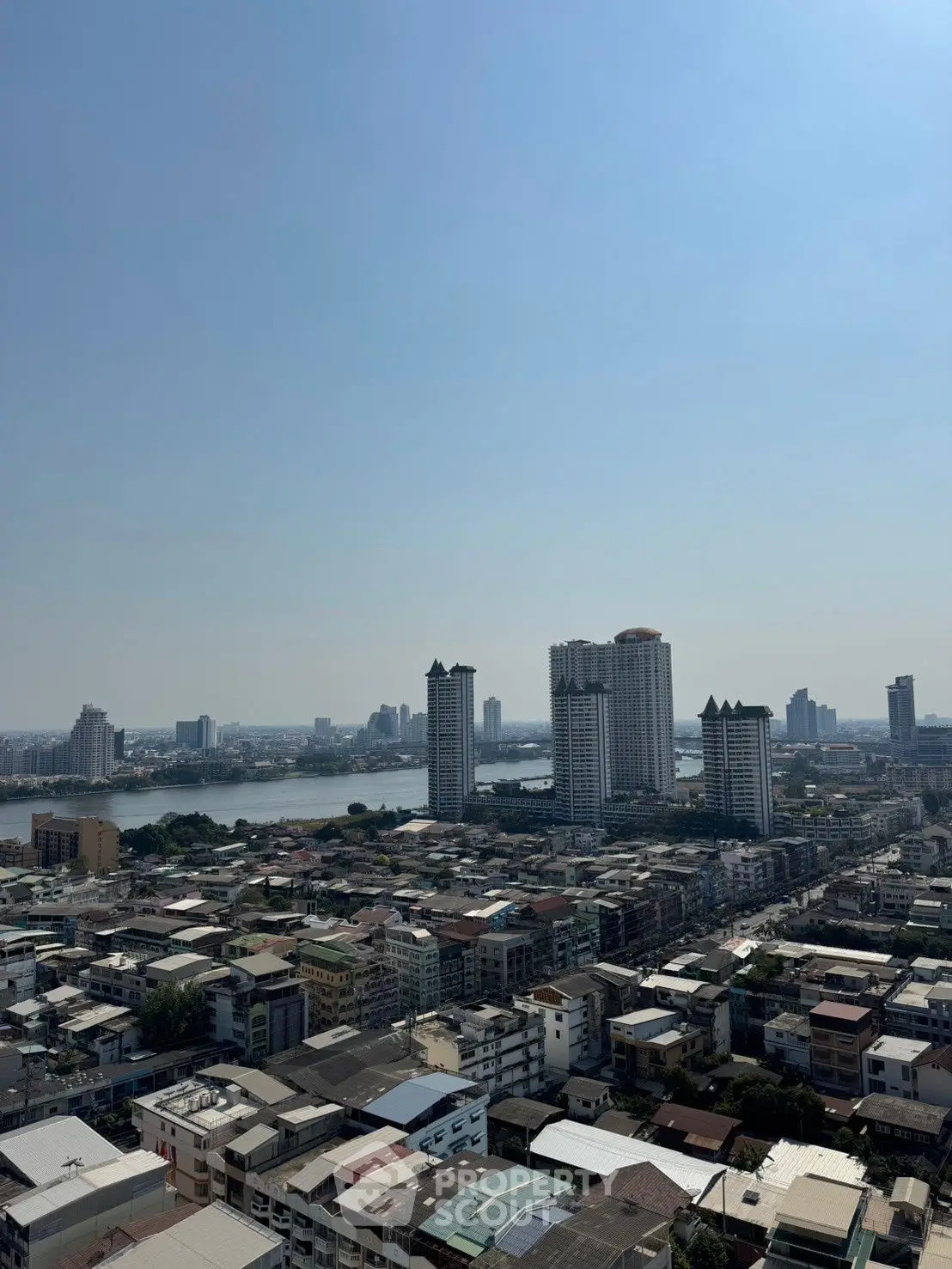 Stunning cityscape view from high-rise building showcasing urban skyline and river.
